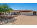 Charming single-story home with desert landscaping, an attached two-car garage and long driveway at 8767 W Villa Hermosa --, Peoria, AZ 85383