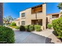 Multi-story home with a stucco exterior, red tile roof, and landscaped front yard at 8787 E Mountain View Rd # 1029, Scottsdale, AZ 85258