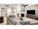 Inviting living room featuring a large sectional sofa, fireplace, and entertainment center at 8787 E Mountain View Rd # 1029, Scottsdale, AZ 85258