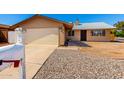 Attractive single-story home with a two-car garage and gravel landscaping for easy upkeep at 9118 W Cameron Dr, Peoria, AZ 85345