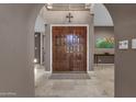 Elegant foyer with marble flooring, arched doorway, and views of the upper level at 9241 S 50Th St, Phoenix, AZ 85044