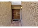 Beautiful double wooden front door under covered entryway with lantern lighting at 9241 S 50Th St, Phoenix, AZ 85044