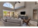 Vaulted ceiling and oversized windows give natural light to this contemporary living room at 9241 S 50Th St, Phoenix, AZ 85044