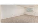 Spacious carpeted bedroom with neutral walls, a window, and white trim at 10401 N 108Th Ave, Sun City, AZ 85351