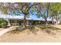 Exterior shot of a well-maintained single story home with mature trees and desert landscaping at 10401 N 108Th Ave, Sun City, AZ 85351