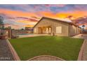 Great outdoor space with artificial turf, pool, built in bar and extended patio at 10809 W Harmony Ln, Peoria, AZ 85373