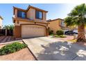 Charming two-story home with a spacious driveway, desert landscaping, and an attached two-car garage at 11429 W Yavapai St, Avondale, AZ 85323