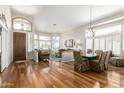 Bright and airy living room with hardwood floors, large windows, and elegant chandelier at 1181 N Dustin Ln, Chandler, AZ 85226