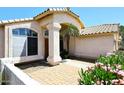 Inviting entryway with decorative tile, pillars, and mature landscaping at 1212 W Vera Ln, Tempe, AZ 85284