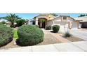 Charming home with mature landscaping and paved walkway leading to the front door at 1212 W Vera Ln, Tempe, AZ 85284