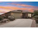 Inviting single-story home features a spacious driveway and a well-maintained desert landscape at 12381 S 182Nd Dr, Goodyear, AZ 85338