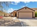 Inviting single-story home featuring a two-car garage and desert landscaping at 12621 W Willow Ave, El Mirage, AZ 85335