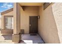 Welcoming front entrance featuring a secure screen door and covered porch area at 12621 W Willow Ave, El Mirage, AZ 85335