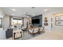 Stylish living room with a decorative accent wall, modern furniture, and large window at 12708 W Corona Ave, Avondale, AZ 85323