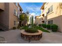Beautiful courtyard with stone planter, desert landscaping, green grass, and views of the condo buildings in Four Peaks at 13700 N Fountain Hills Blvd # 155, Fountain Hills, AZ 85268