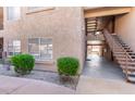 Exterior condo elevation with stairs, small bushes, and gravel in the Four Peaks condominium community at 13700 N Fountain Hills Blvd # 155, Fountain Hills, AZ 85268