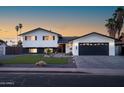 Charming two-story home with manicured lawn, attractive landscaping, and a paved driveway at 1630 E Minton Dr, Tempe, AZ 85282