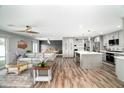 Open-concept living space with luxury vinyl plank floors, a modern kitchen and a comfortable living room at 1630 E Minton Dr, Tempe, AZ 85282