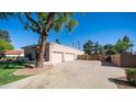 Large driveway leads to a two-car garage in this tan single Gathering home at 1739 E Knox Rd, Tempe, AZ 85284
