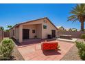 Outdoor patio with an orange chair, a spa, and views of the home's back exterior at 174 W Del Rio St, Gilbert, AZ 85233