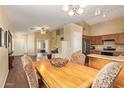 Open-concept living and dining area with a light wood table, upholstered chairs and views into the kitchen at 174 W Del Rio St, Gilbert, AZ 85233