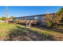 Exterior view of a single story home with a wooden deck and well maintained lawn at 17913 E Watford Dr, Queen Creek, AZ 85142