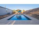 Backyard pool with concrete trim, wooden gazebo, and privacy fence; perfect for outdoor relaxation at 17913 E Watford Dr, Queen Creek, AZ 85142