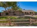 Well-kept home with lush green lawn, mature trees, and a quaint fence, perfect for curb appeal at 1817 W Seldon Ln, Phoenix, AZ 85021