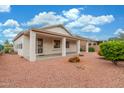 Expansive backyard with a covered patio, perfect for outdoor entertaining and relaxation at 18562 N Alamo Dr, Surprise, AZ 85374