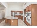 Bright kitchen features ample cabinet space, stainless steel appliances, and a large center island at 18562 N Alamo Dr, Surprise, AZ 85374