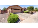 Single-story home featuring desert landscaping, a two-car garage, and an extended driveway at 18896 N Lariat Rd, Maricopa, AZ 85138
