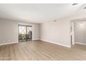 Bright living room with neutral paint, vinyl floors, and sliding glass doors at 1920 W Lindner Ave # 116, Mesa, AZ 85202