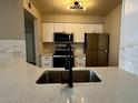 Modern kitchen with white cabinets, stainless steel appliances, and a stylish faucet at 2025 E Campbell Ave # 132, Phoenix, AZ 85016