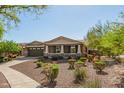 Inviting single-Gathering home with a covered front porch, desert landscaping, and an attached two-car garage at 2674 N Saide Ln, Buckeye, AZ 85396