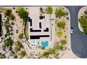 Aerial view of a desert home featuring solar panels, heart-shaped pool, and beautifully landscaped surroundings at 28019 N 115 Pl, Scottsdale, AZ 85262