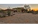 Stunning Southwestern-style home with desert landscaping and a charming red tile roof at sunset at 2918 N 90Th St, Mesa, AZ 85207