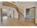 Bright, open living room with hardwood floors, a grand staircase, and elegant wood detailing at 2918 N 90Th St, Mesa, AZ 85207