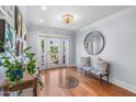 Welcoming foyer with hardwood floors, bench seating and natural light at 3411 E Sells Dr, Phoenix, AZ 85018