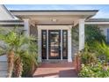 Inviting front door with brick columns, lush plants and manicured landscaping at 3411 E Sells Dr, Phoenix, AZ 85018