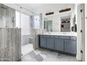 Elegant bathroom featuring a glass shower, double vanity, and modern fixtures at 35616 N 34Th Ln, Phoenix, AZ 85086