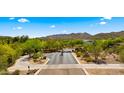 Aerial view of gated entrance to a planned community surrounded by lush desert landscaping at 38940 N 54Th St, Cave Creek, AZ 85331