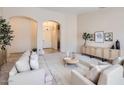 Inviting living room featuring neutral paint, modern furnishings, neutral carpet, and archways at 4346 E Prickly Pear Trl, Phoenix, AZ 85050
