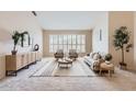 Inviting living room with plantation shutters, neutral paint, modern furnishings, and neutral carpet at 4346 E Prickly Pear Trl, Phoenix, AZ 85050