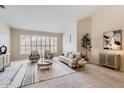 Inviting living room with plantation shutters, neutral paint, modern furnishings, and neutral carpet at 4346 E Prickly Pear Trl, Phoenix, AZ 85050