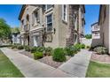 Lovely townhome with stone accents, shutters, and manicured landscaping at 5729 S 21St Ter, Phoenix, AZ 85040