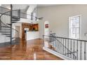 Bright living room features hardwood floors, spiral staircase, and seamless flow into the kitchen at 5729 S 21St Ter, Phoenix, AZ 85040
