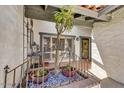 Inviting front porch with decorative ironwork, potted plants, and a view of the entryway at 5738 N Scottsdale Rd, Scottsdale, AZ 85253