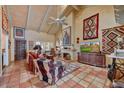 Cozy living room with high ceilings, tile floors, a fireplace, and southwestern decor at 5738 N Scottsdale Rd, Scottsdale, AZ 85253