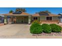 Inviting home exterior with covered parking, solar panels, and well-maintained landscaping at 6014 W Evans Dr, Glendale, AZ 85306