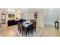 Open concept dining room with views into the living room with dark wood furniture at 609 E Winter Dr, Phoenix, AZ 85020
